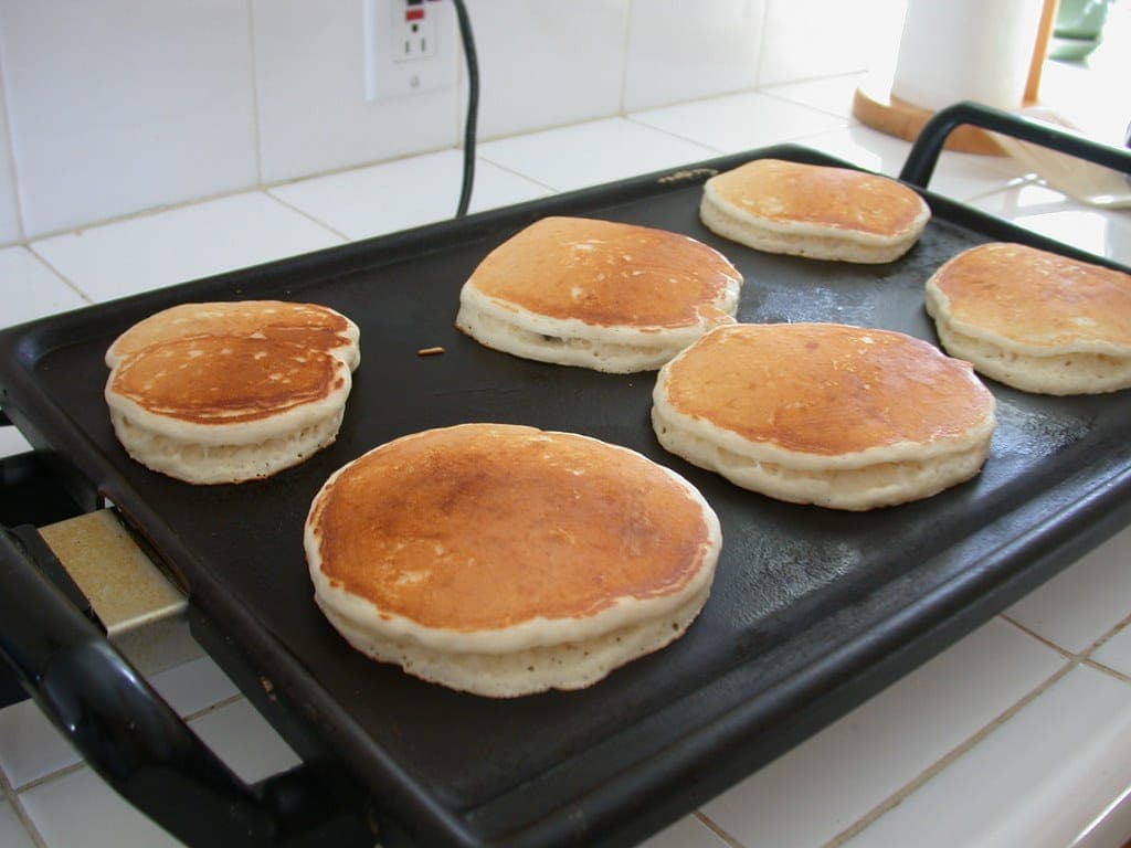 Pancakes cooking on a griddle
