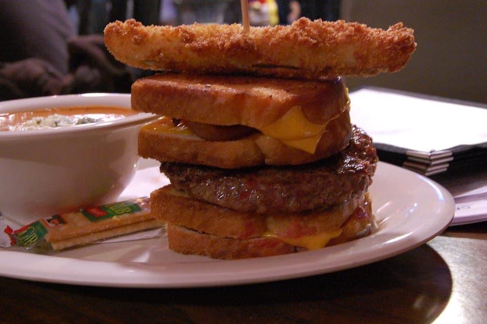 A bacon and cheese melt cooked on a flat surface