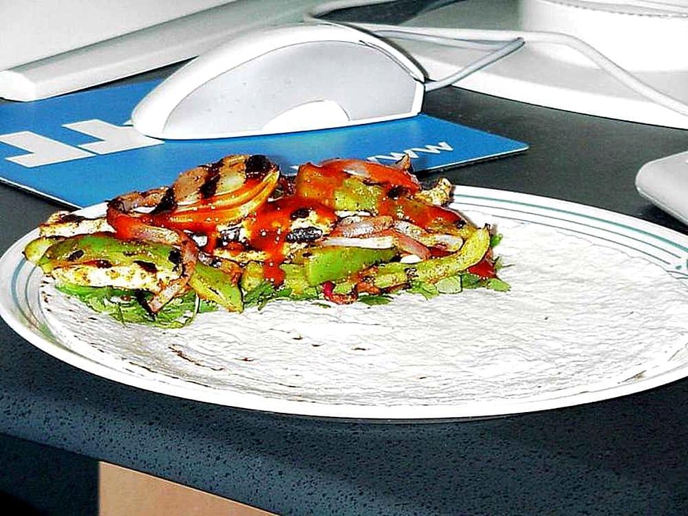 Chicken fajitas cooking with bell peppers and onions