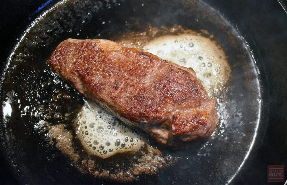 A steak seared in a cast iron pan