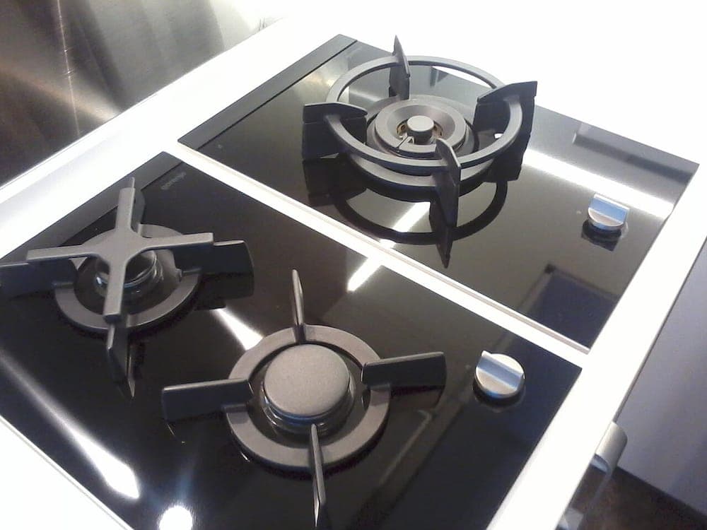 A kitchen with multiple cooktops built into the counter