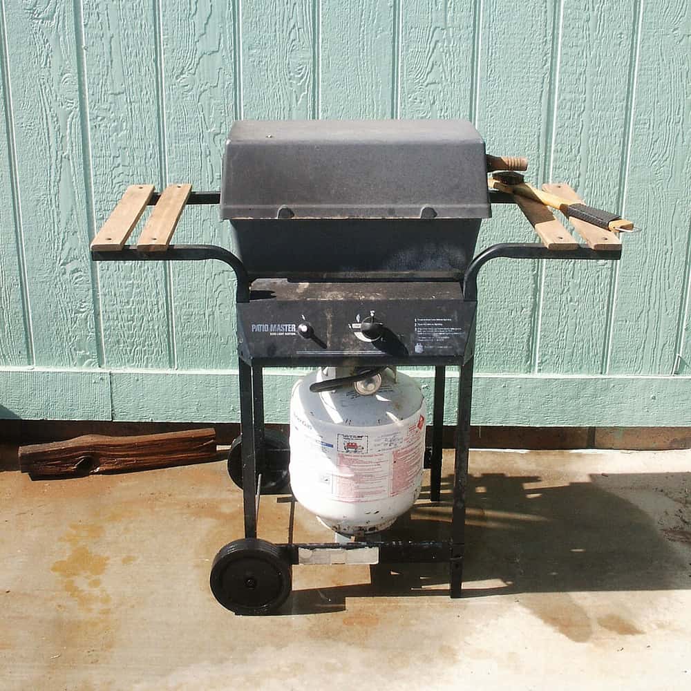 A propane gas grill with the lid open