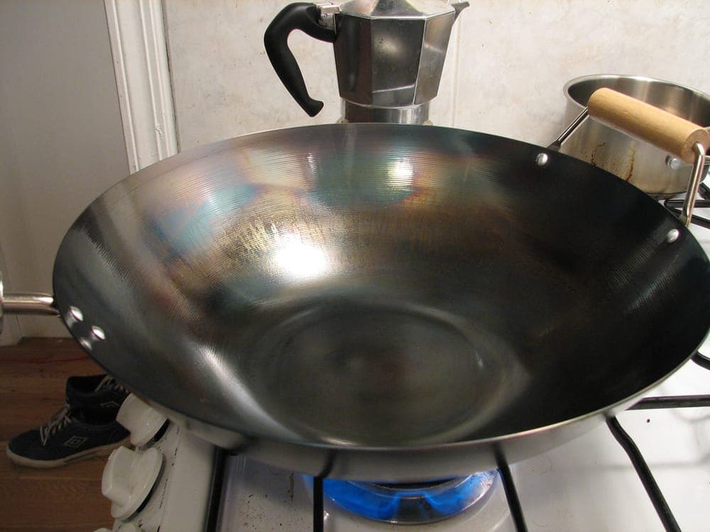 A dark, well-seasoned steel cooking surface